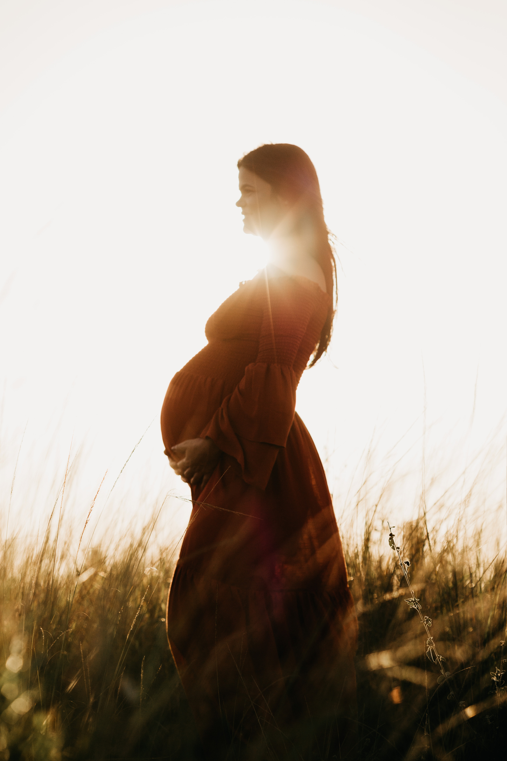Pregnant woman in grassy field
